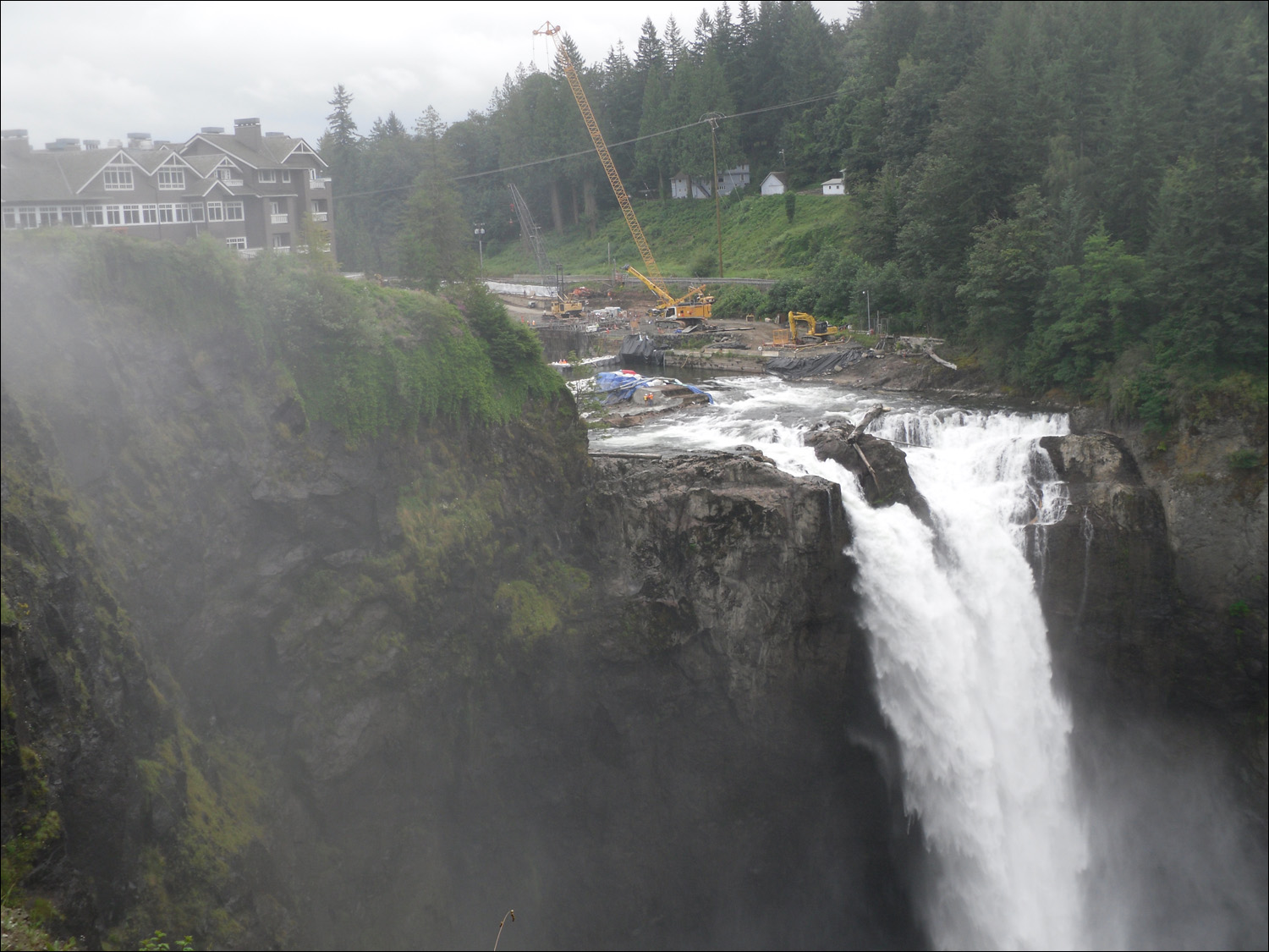 Snoqualmie, WA- Snoqualmie Falls with construction, in background, of new hydro-electric plant